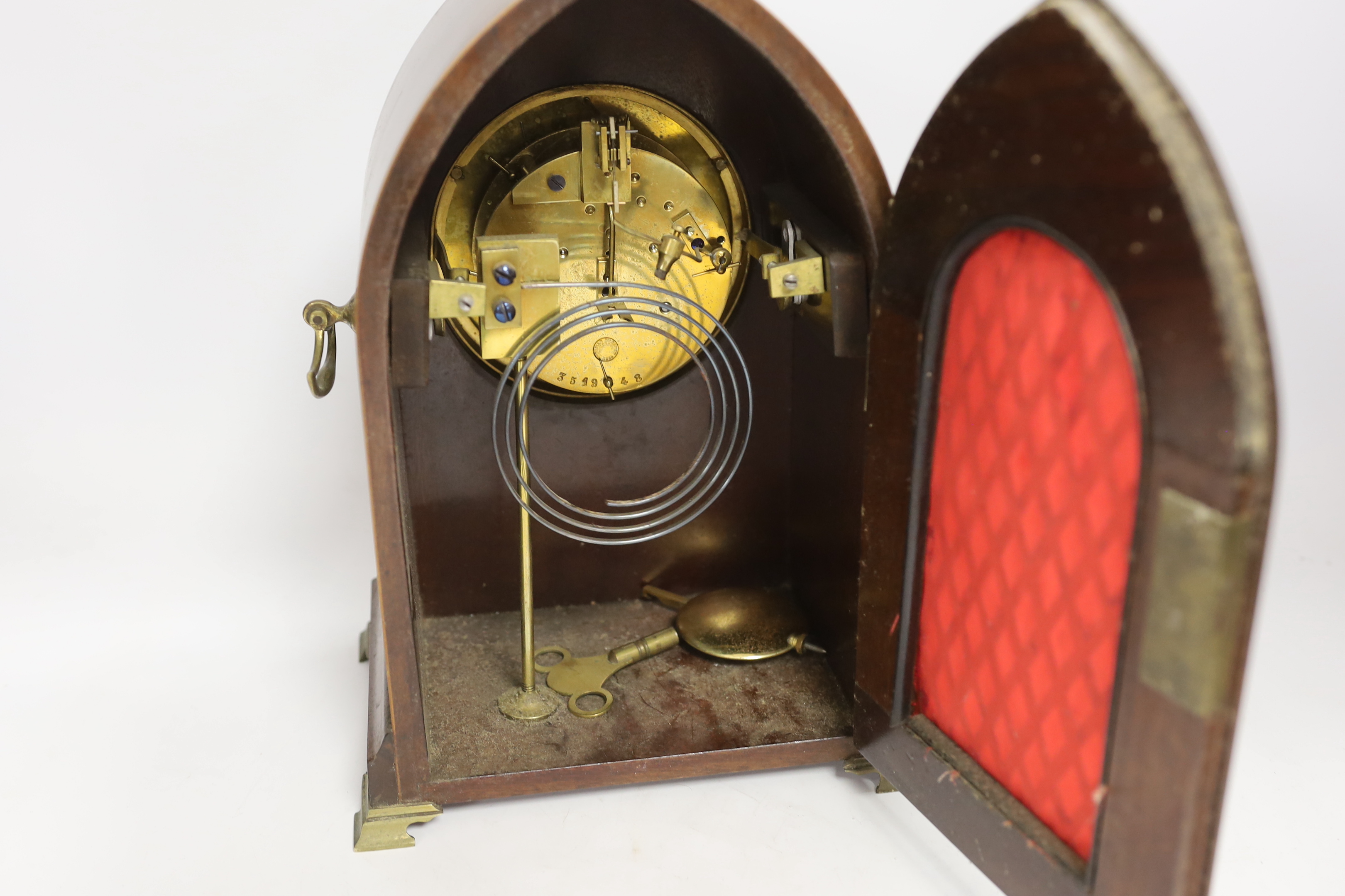 A late 19th century mahogany lancet shaped mantel clock, striking on a coiled gong, 29cm high